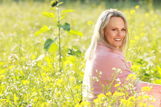 happy mature woman  in a flowerfield