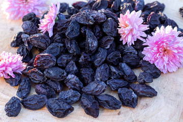 Prunes on wooden background, top view.