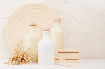 Blank white, beige cosmetics bottles with spikelets on white wood board, copy space, mock up. Soft elegant home decor for advertising, designers, branding identity, cover.