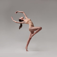 young beautiful ballet dancer in beige swimsuit - obrazy, fototapety, plakaty