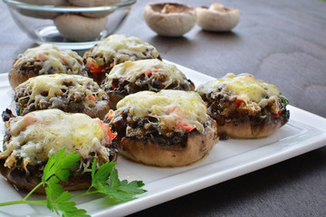 Stuffed mushrooms with cheese, bacon and vegetables