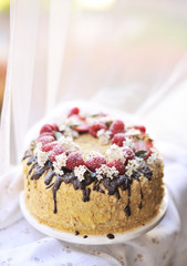 honey cake, decorated with berries and chocolate. sweet family dinner. holiday cake. on the balcony breakfast