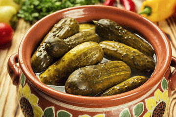 Pickles.marinated pickled cucumbers in bowl,Marinated cucumbers gherkins.Pickles with mustard and garlic on a stone background.homemade pickles,traditional Russian snack.Preservation. Selective focus.