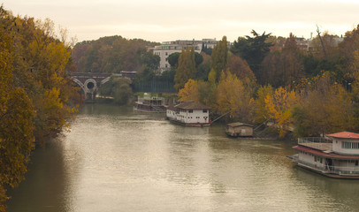 river in autumn. barge on the river. Autumn in the city. Rome. italian nature