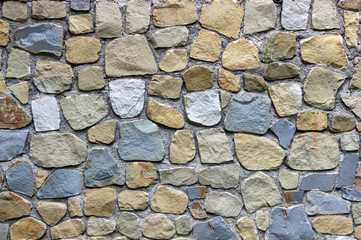 wall of colored granite stone of rounded shape