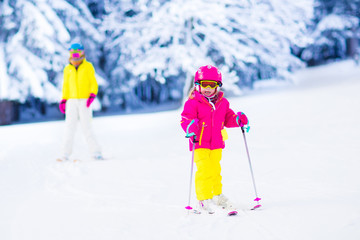 Family ski and snow fun in winter mountains