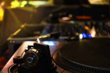 Fototapeta na wymiar Colorful turntable DJ party at nightclub with lowkey and soft focus