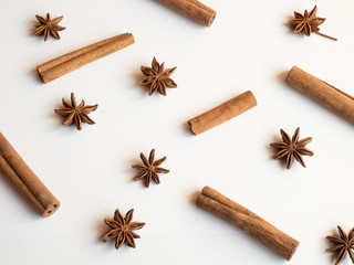 Cinnamon sticks spice stars on a white background lying Flat lay