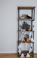 Halloween decorations on a rustic industrial shelving unit