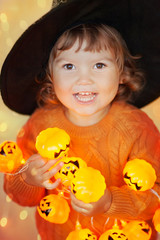 Little kid with halloween decorations.