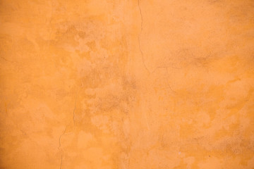 Italian plaster wall in yellow, ochre hues. Background