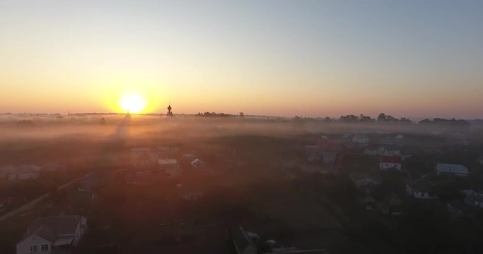Air view of the village with fog, inium, church and river