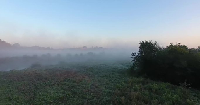Air view of the village with fog, inium, church and river