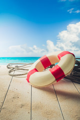 life saver on a dock at the beach, summer vacations