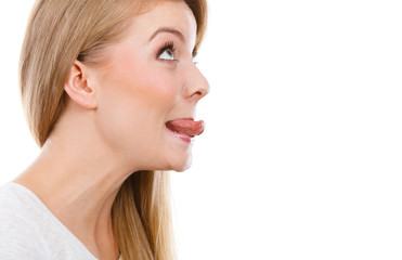 Fototapeta premium Funny blonde woman sitcking tongue out