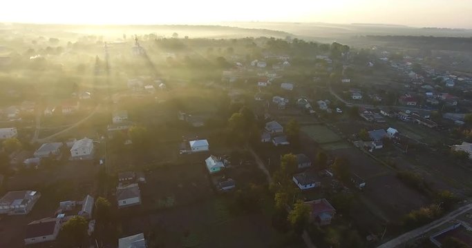 Air view of the village with fog, inium, church and river