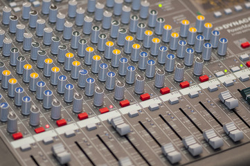 Close-up on knobs of an audio console. Digital audio board. Studio workstation. Mixing console.