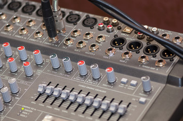 Close-up on knobs of an audio console. Digital audio board. Studio workstation. Mixing console.