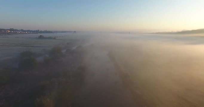 Air view of the village with fog, inium, church and river