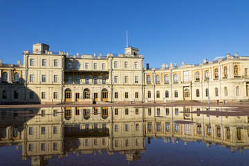 Fototapeta premium Russia, suburb of St. Petersburg. Great Gatchina Palace (1766 — 1781) and parade-ground. Reflection in pools after a rain.