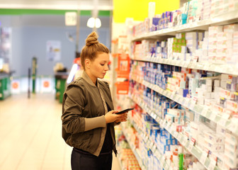 Woman choosing a dairy products at supermarket 