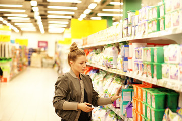 Woman choosing a dairy products at supermarket 