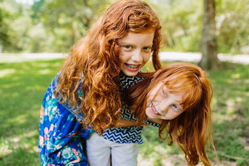 Two young red headed sisters / siblings