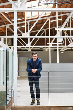 Portrait of millennial at work in modern design office