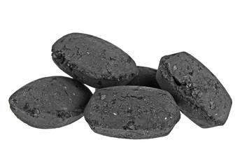 Heap of coal briquette for BBQ isolated on white background