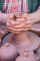Man doing with his hands and I sweep jars                                        Hands, mud and crafts