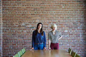 Portrait of two millennial businesswoman at tech start up office