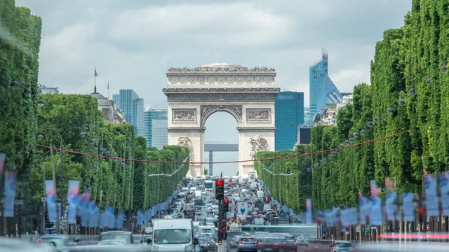 Arc de Triomphe viewed up the Champs Elysees with traffic timelapse. Paris, France