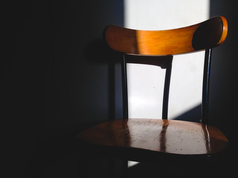 Sunlit chair through a window