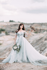 Fototapeta na wymiar bride with owls and printing, the bride's bouquet and the sunset