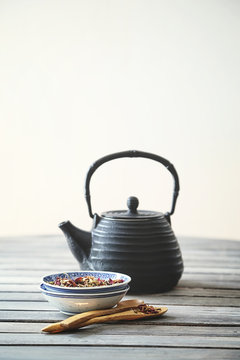 Black teapot with aromatic tea leaves