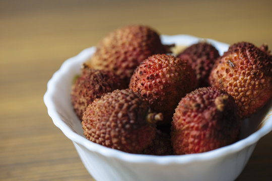 Litchis on a white bowl.