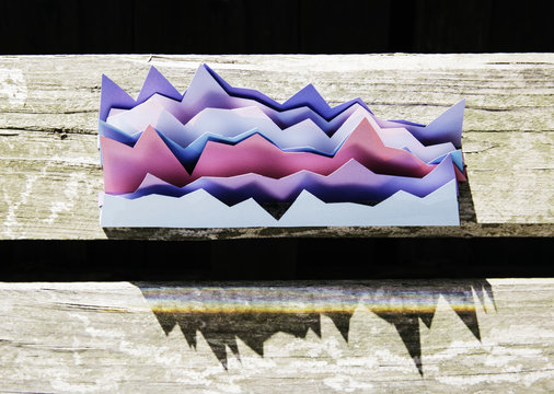 Overhead photo of colorful charts on a wooden surface wtih shadows