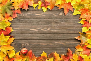 fallen leaves on wooden background, top view, copy space