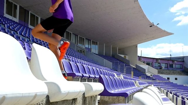Top view of track runner boy teenager running in a stadium, slow motion