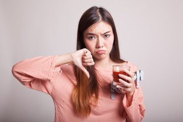 Asian woman thumbs down  hate tomato juice.