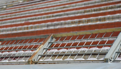 Fototapeta premium Robust metal protection net in the stadium to separate fans on t