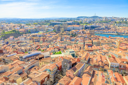 Oporto urban landscape on Douro River and city skyline from Clerigos Tower, the highest point in the city of Porto. Cathedral or Se do Porto and Episcopal Palace or Paco Episcopal on background.