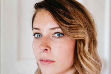 close up portrait of young woman with blue eyes indoors
