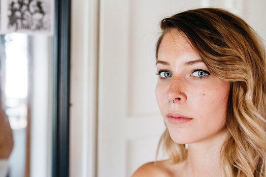 close up portrait of young woman with blue eyes indoors