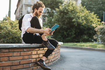 Young businessman using a digital tablet in the city