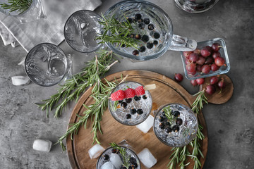 Composition with fresh rosemary drink on table