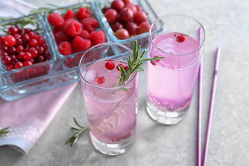 Glasses with fresh rosemary drink on table