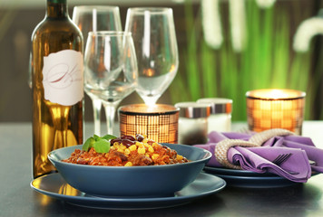 Bowl with delicious chili con carne on served table