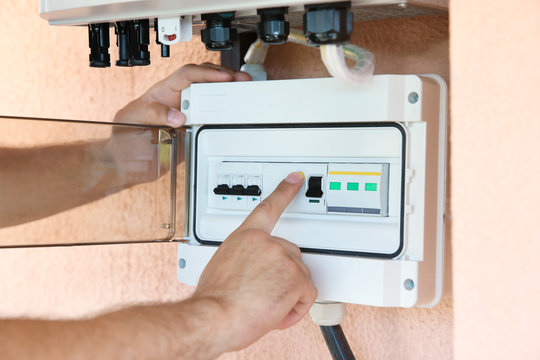 Worker connecting solar panels to control unit