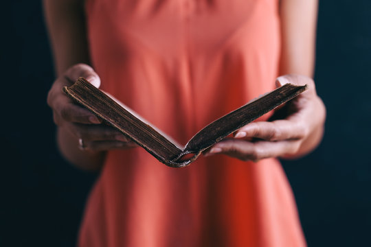 Closeup of a woman reading an old book.